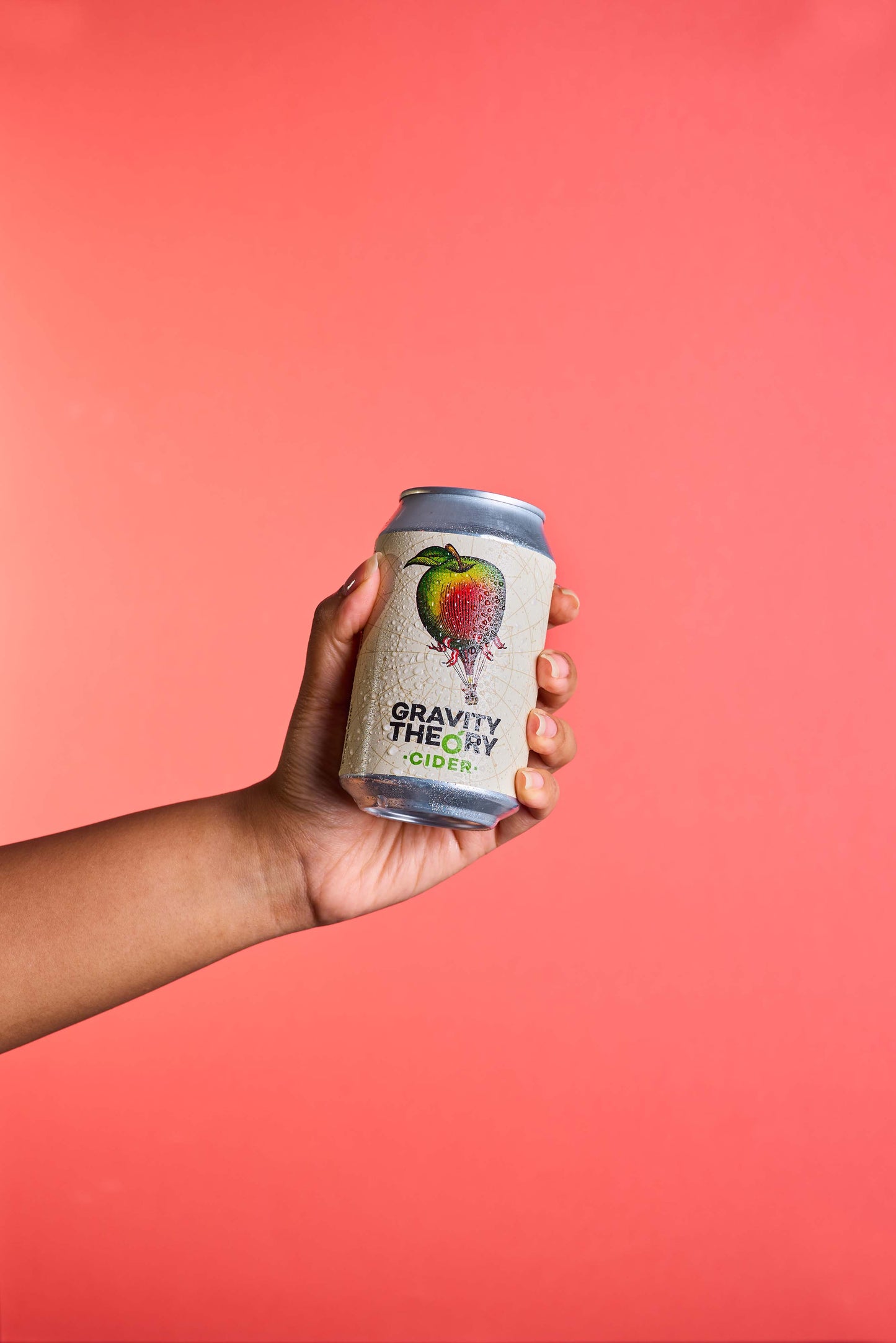 Gravity theory cider can on peach background