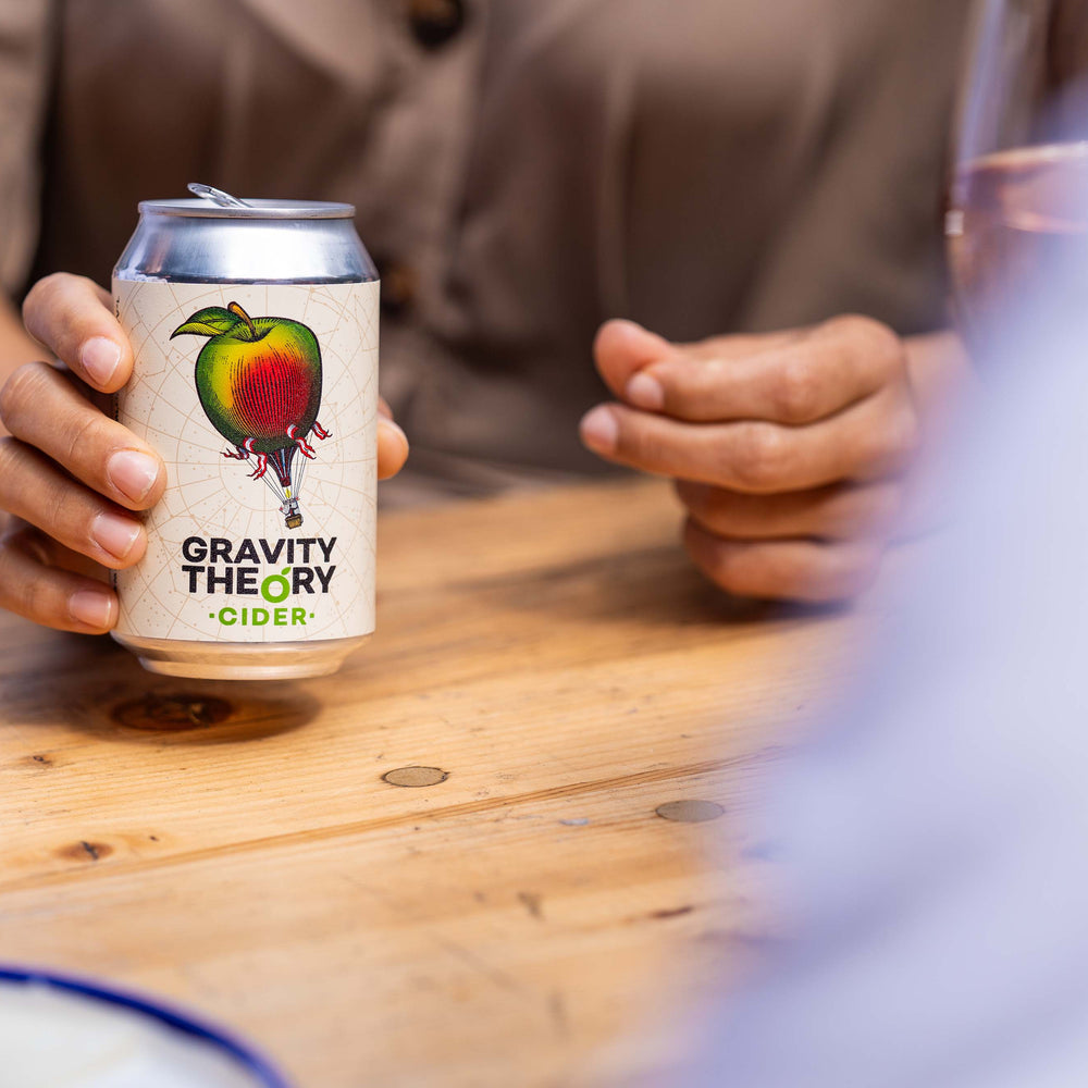 Gravity Theory Cider woman holding can